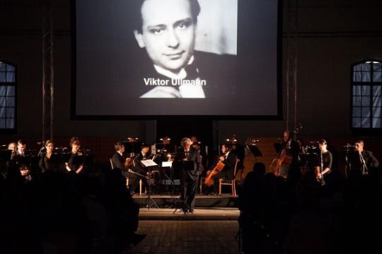 Maestro Murry Sidlin introduces composer Viktor Ullmann to the audience during the premiere of Hours of Freedom. Photo credit: John Campbell